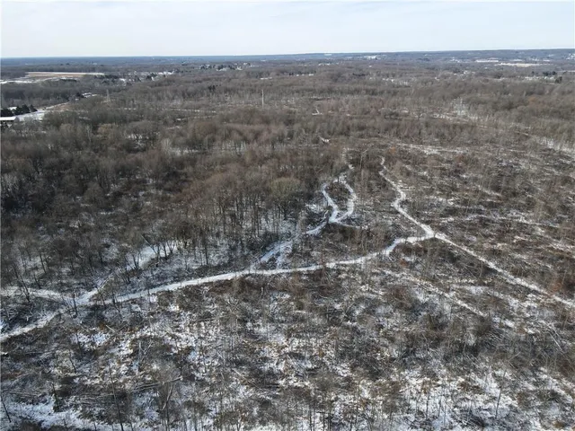 an aerial view of house with yard and mountain view in back