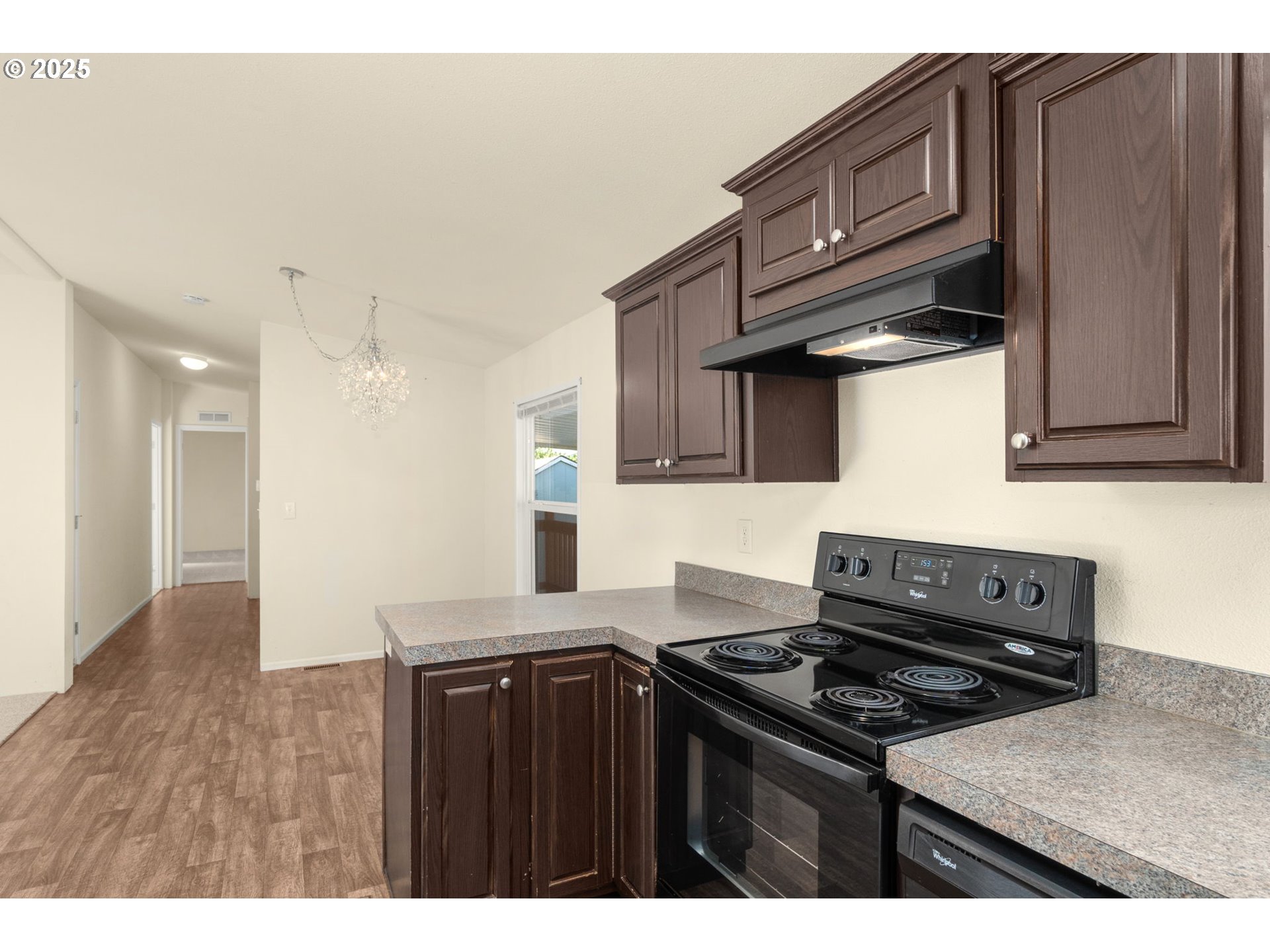 21100 Northeast Sandy Boulevard, Unit 76 Fairview, OR 97024 - Photo 11 of 23 a kitchen with granite countertop a stove top oven a sink dishwasher and cabinets with wooden floor