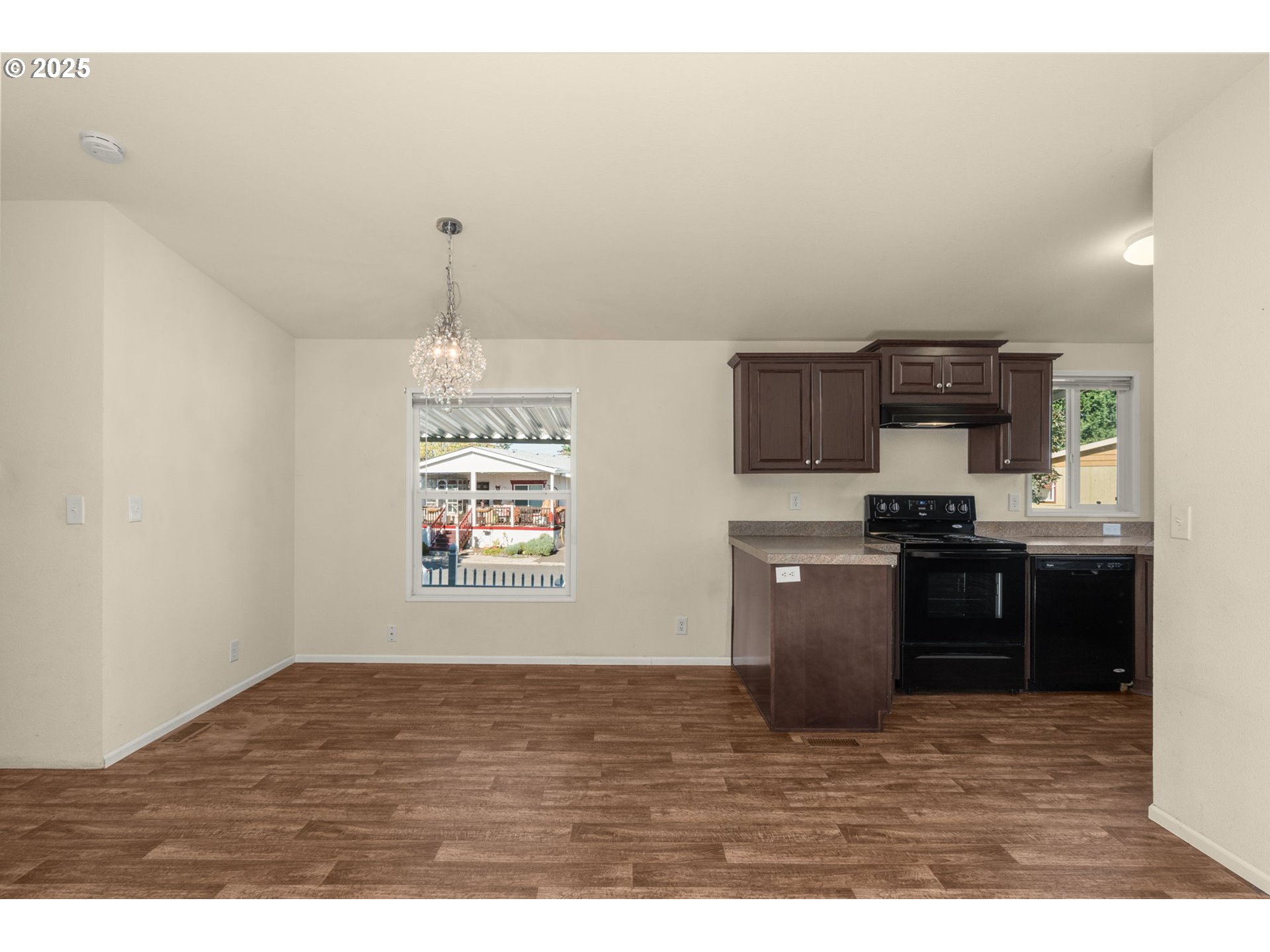 21100 Northeast Sandy Boulevard, Unit 76 Fairview, OR 97024 - Photo 12 of 23 a kitchen with kitchen island granite countertop a stove top oven a sink a counter space and cabinets