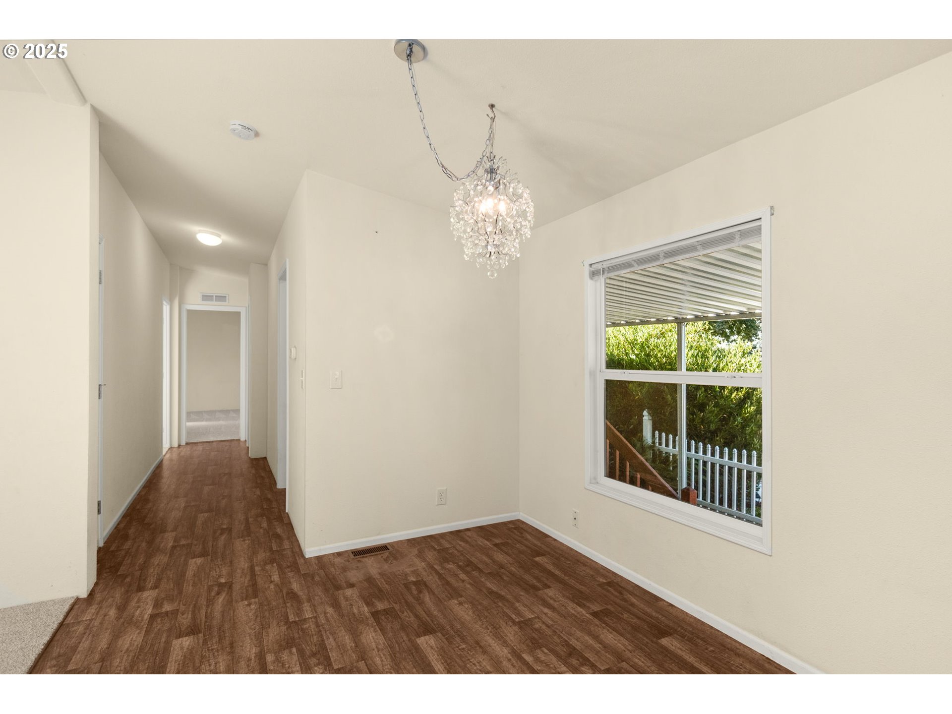 21100 Northeast Sandy Boulevard, Unit 76 Fairview, OR 97024 - Photo 13 of 23 a view of a livingroom with a chandelier and wooden floor