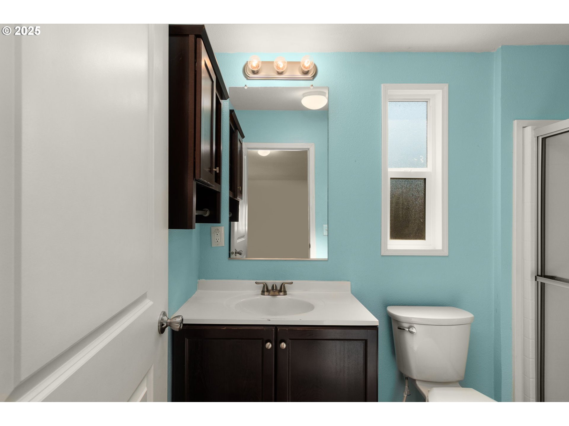 21100 Northeast Sandy Boulevard, Unit 76 Fairview, OR 97024 - Photo 16 of 23 a bathroom with a toilet a sink and mirror