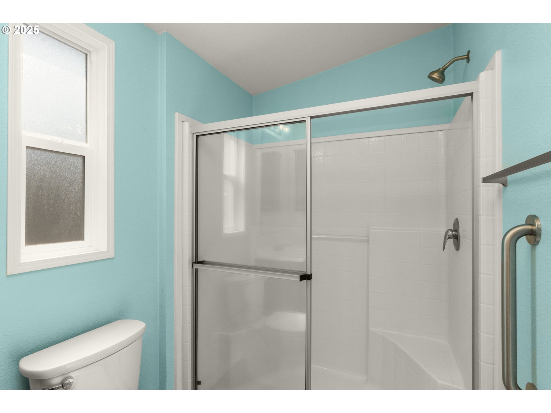 21100 Northeast Sandy Boulevard, Unit 76 Fairview, OR 97024 - Photo 17 of 23 a bathroom with a shower and a toilet