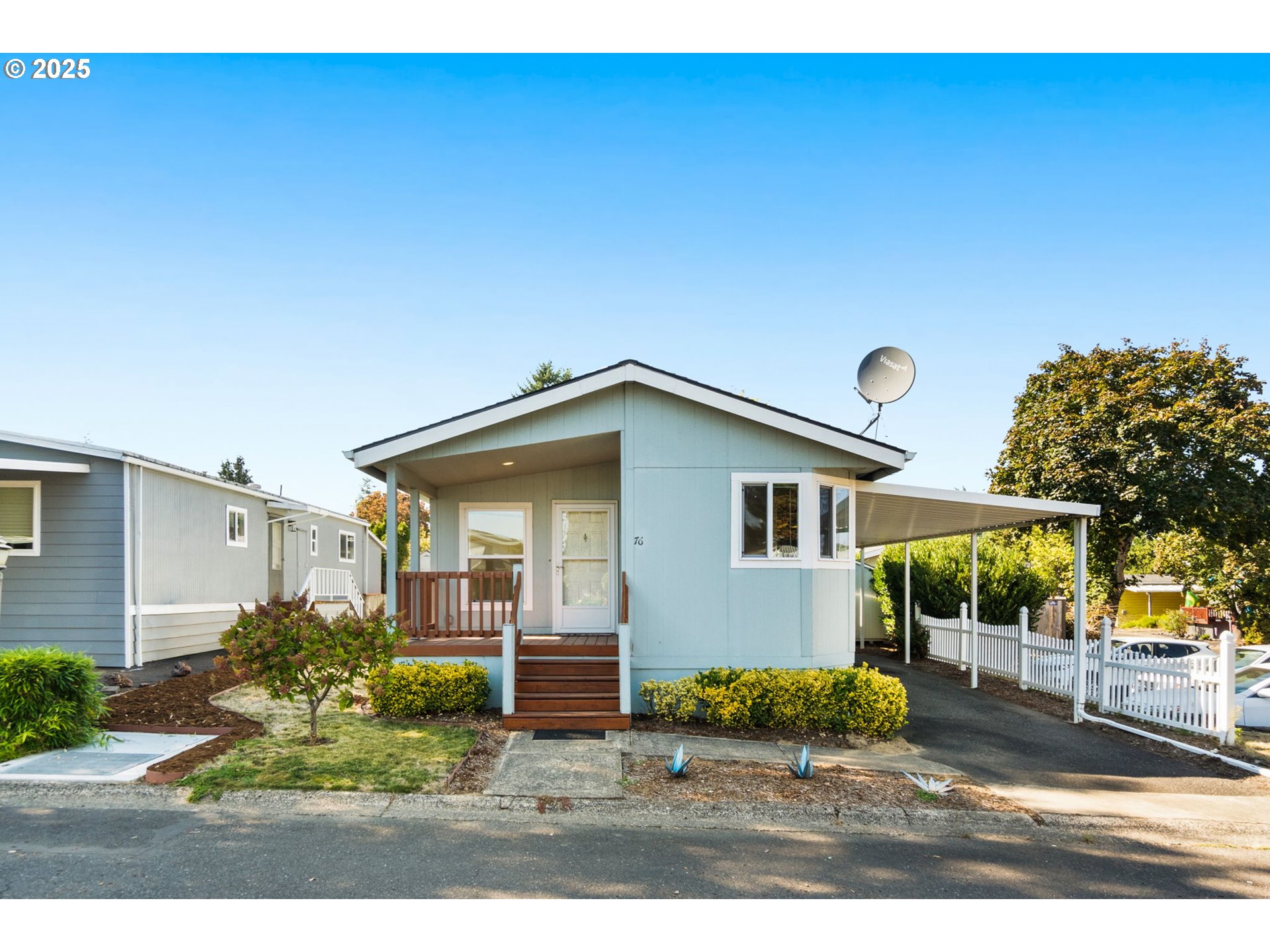 21100 Northeast Sandy Boulevard, Unit 76 Fairview, OR 97024 - Photo 2 of 23 a front view of a house with garden