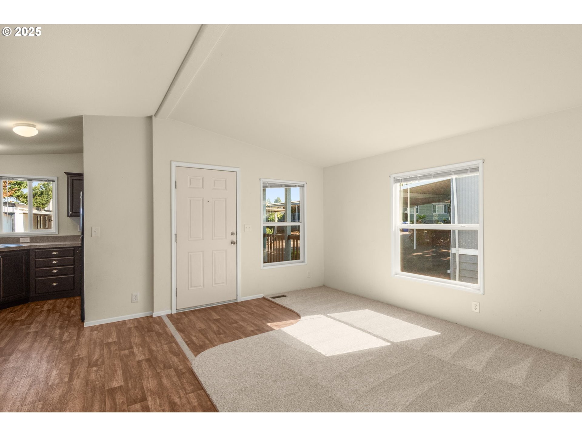 21100 Northeast Sandy Boulevard, Unit 76 Fairview, OR 97024 - Photo 5 of 23 a view of an empty room with wooden floor and a window