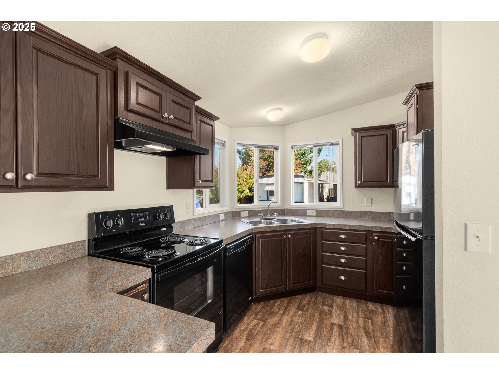 21100 Northeast Sandy Boulevard, Unit 76 Fairview, OR 97024 - Photo 9 of 23 a kitchen with granite countertop a sink cabinets and stainless steel appliances