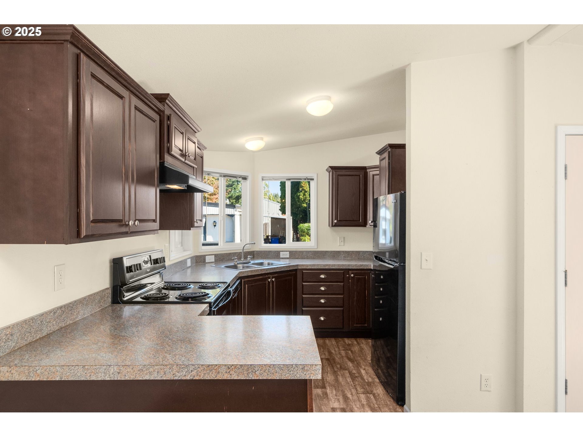 21100 Northeast Sandy Boulevard, Unit 76 Fairview, OR 97024 - Photo 10 of 23 a kitchen with stainless steel appliances granite countertop a sink refrigerator and stove