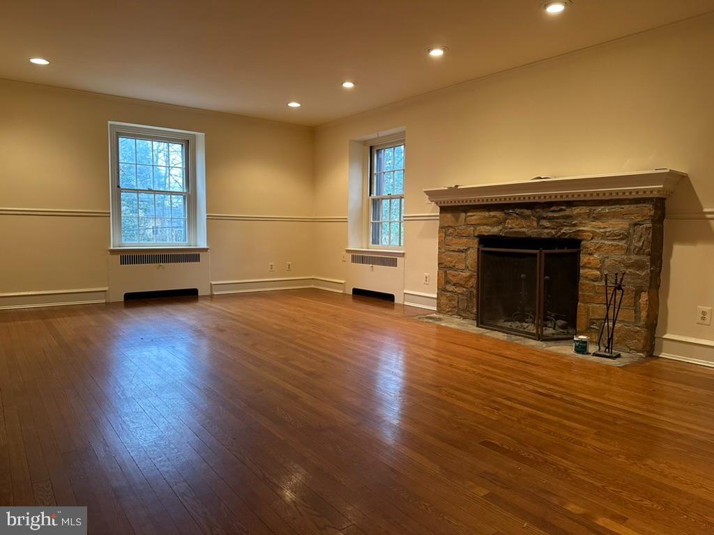 602 Bellevue Road Wilmington, DE 19809 - Photo 16 of 56 a view of empty room with wooden floor and fireplace