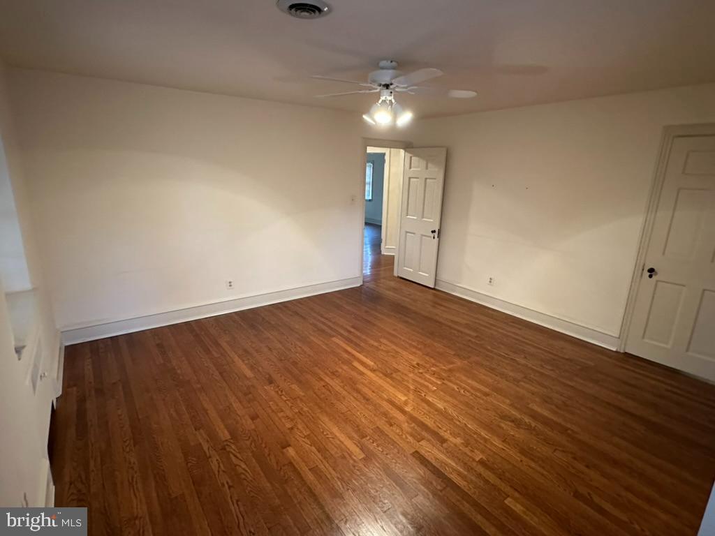 602 Bellevue Road Wilmington, DE 19809 - Photo 29 of 56 an empty room with wooden floor and windows