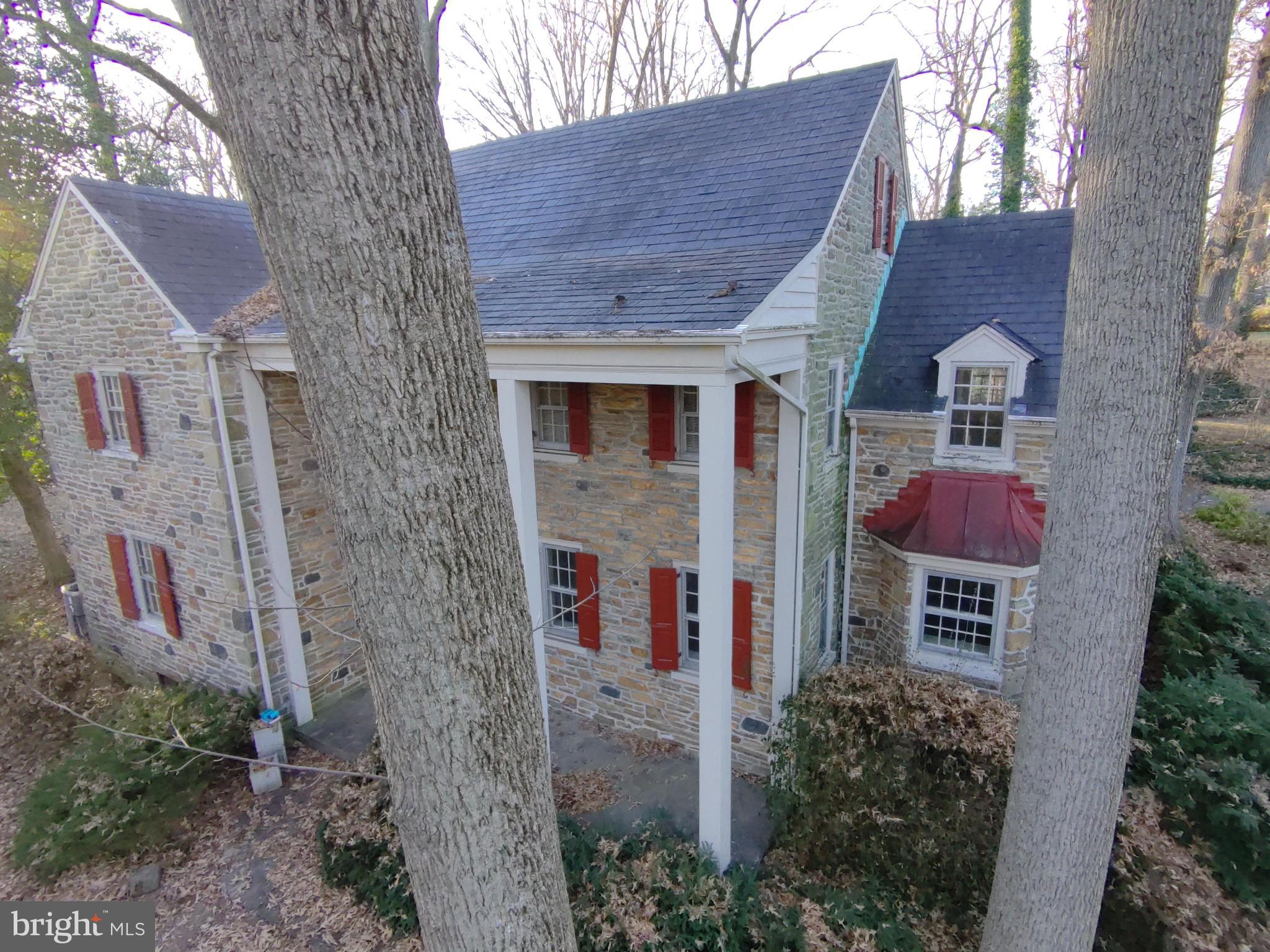 602 Bellevue Road Wilmington, DE 19809 - Photo 3 of 56 a view of a brick house with a small yard and large tree