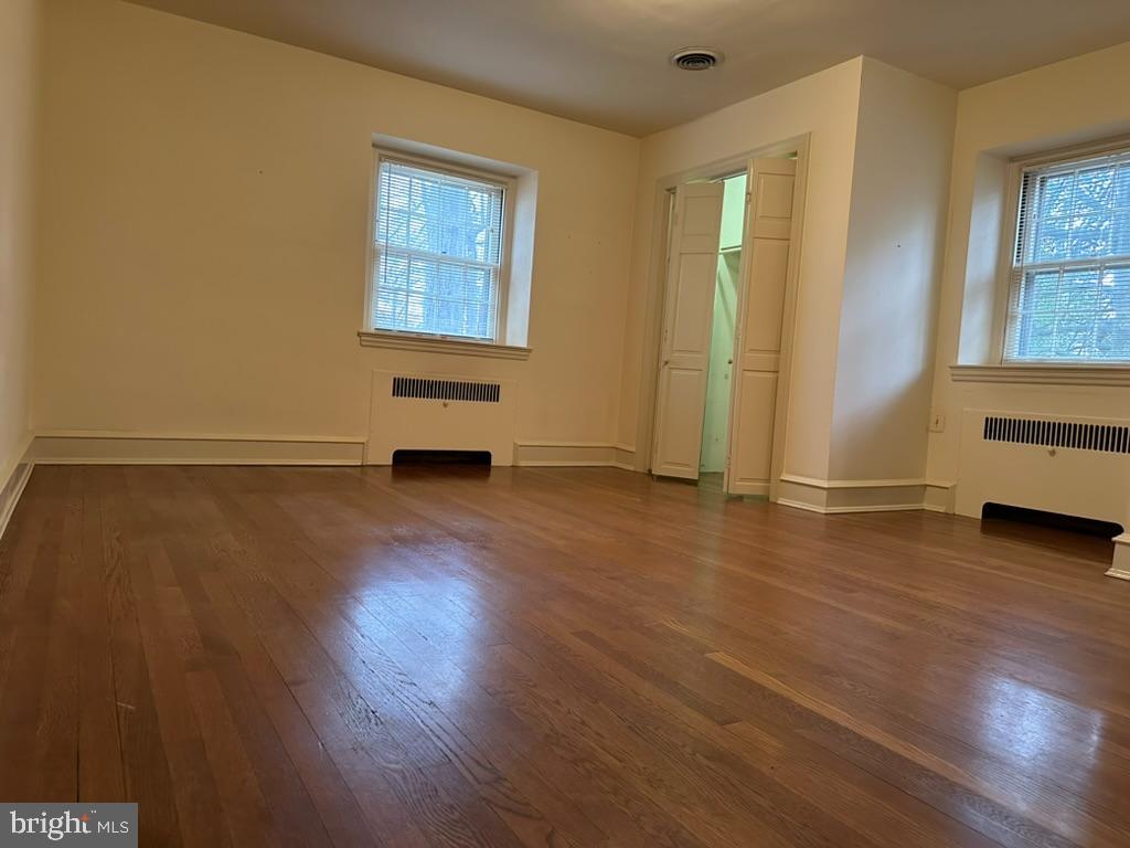 602 Bellevue Road Wilmington, DE 19809 - Photo 43 of 56 an empty room with wooden floor and windows