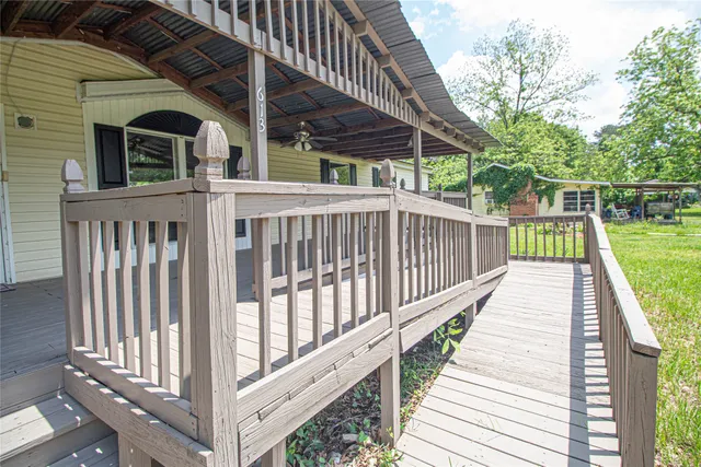 a view of a wooden deck with a yard