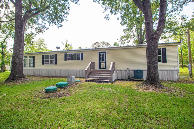 a house view with a sitting space and garden