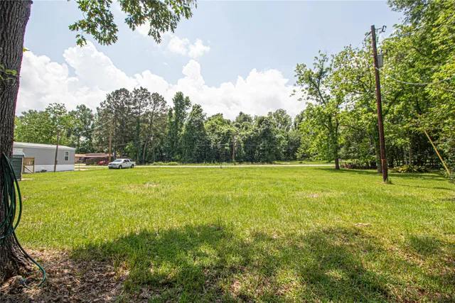 a view of outdoor space with deck and trees