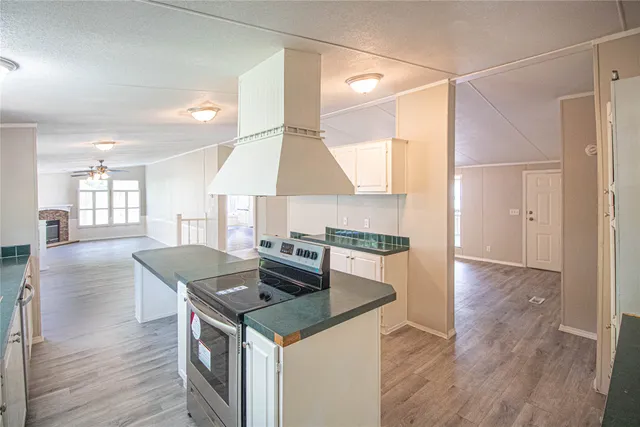 a kitchen with granite countertop a stove and a refrigerator