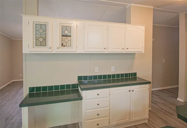 a kitchen with white cabinets and a stove