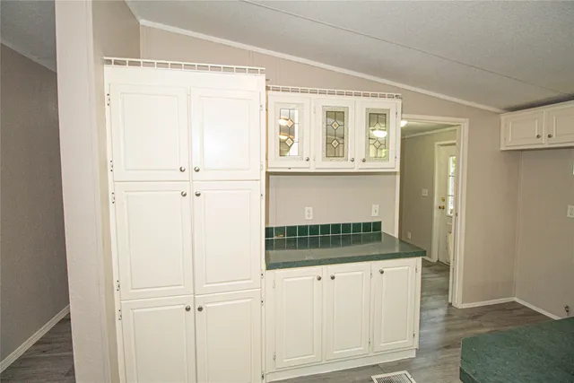 a view of cabinets and wooden floor