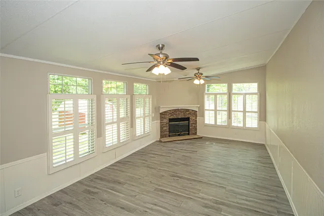 a view of livingroom with furniture chandelier fan and fire place
