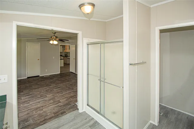 a view of a hallway with wooden floor