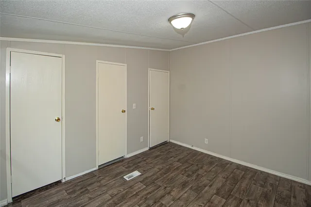 a view of a room with wooden floor