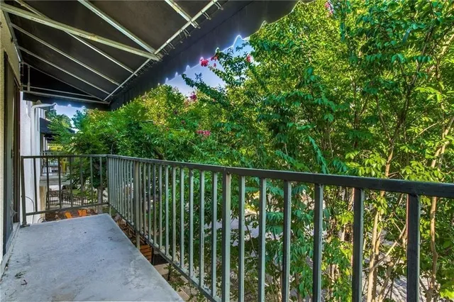 a balcony with trees in front of it