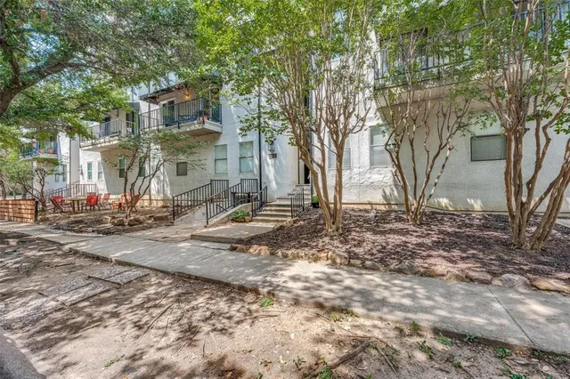 a view of a backyard with large trees
