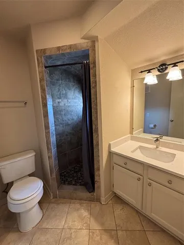 a bathroom with a toilet sink and shower