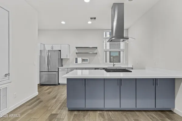 a kitchen with a sink and wooden floor