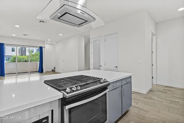 a view of kitchen and hall with wooden floor