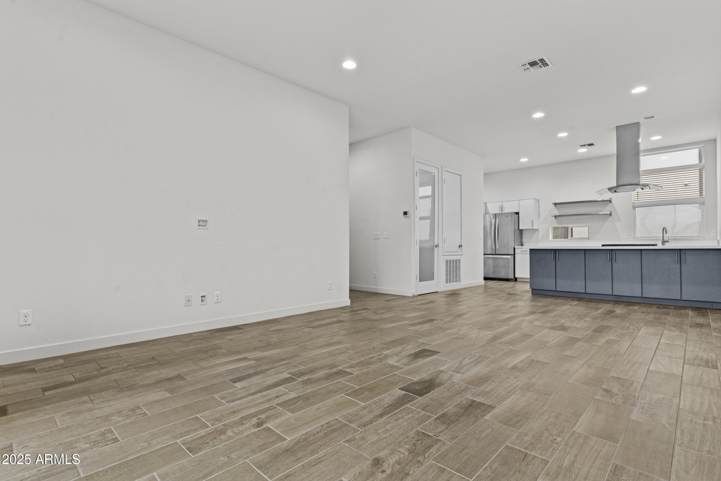 325 East Coronado Road, Unit 8 Phoenix, AZ 85004 - Photo 15 of 34 an empty room with kitchen and natural light