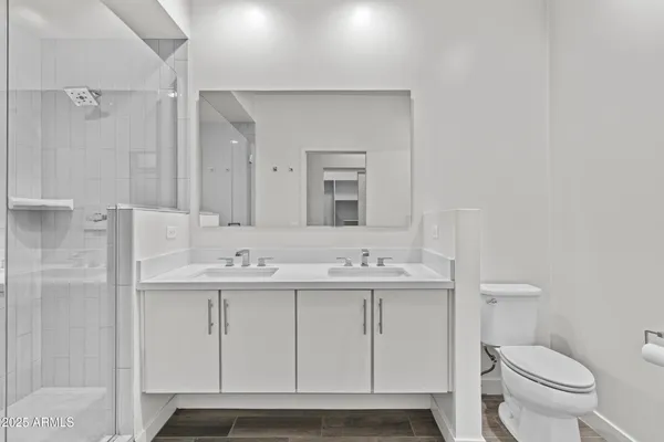 a bathroom with a shower sink vanity and mirror