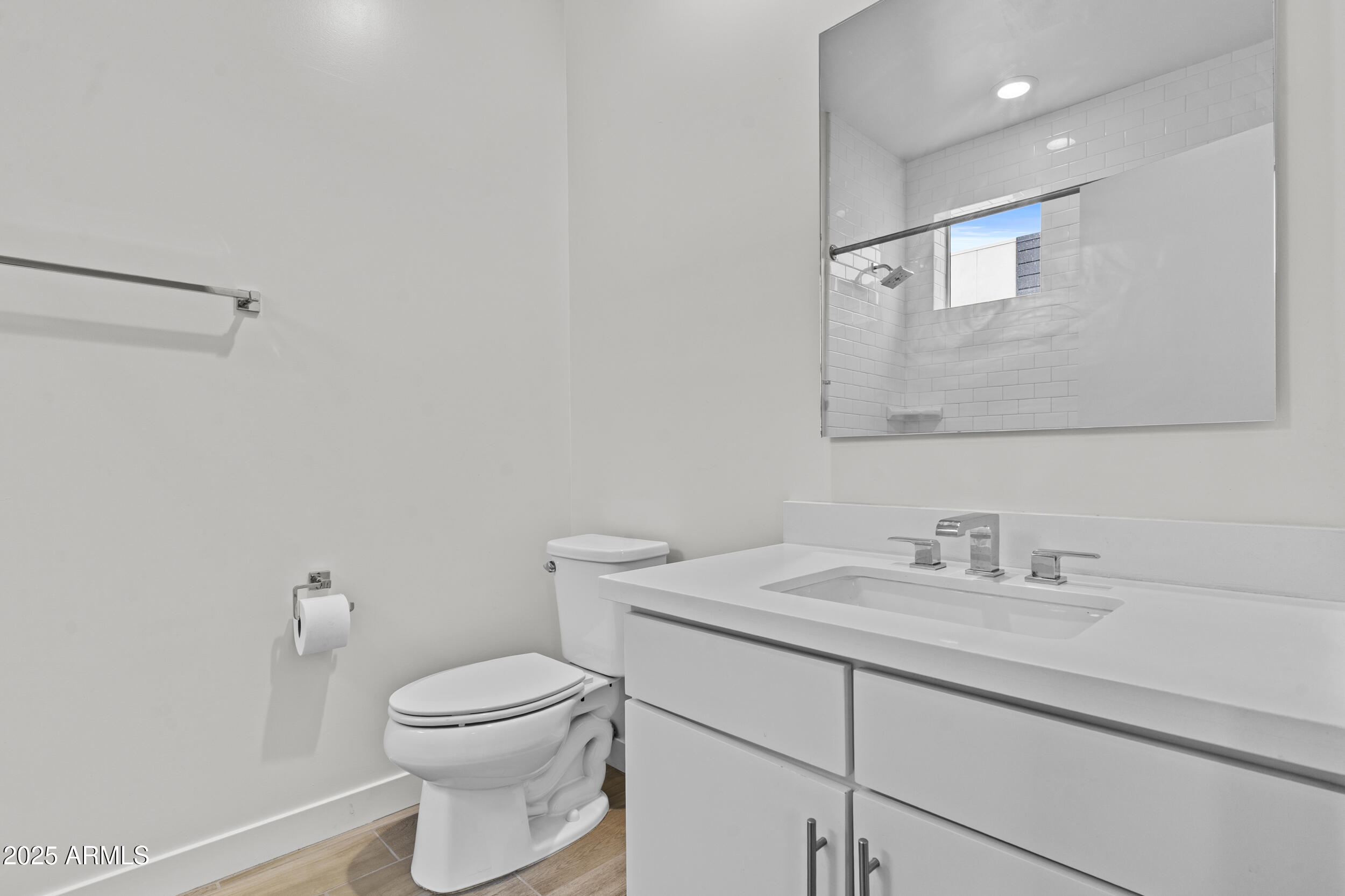 325 East Coronado Road, Unit 8 Phoenix, AZ 85004 - Photo 27 of 34 a bathroom with a toilet a sink and mirror