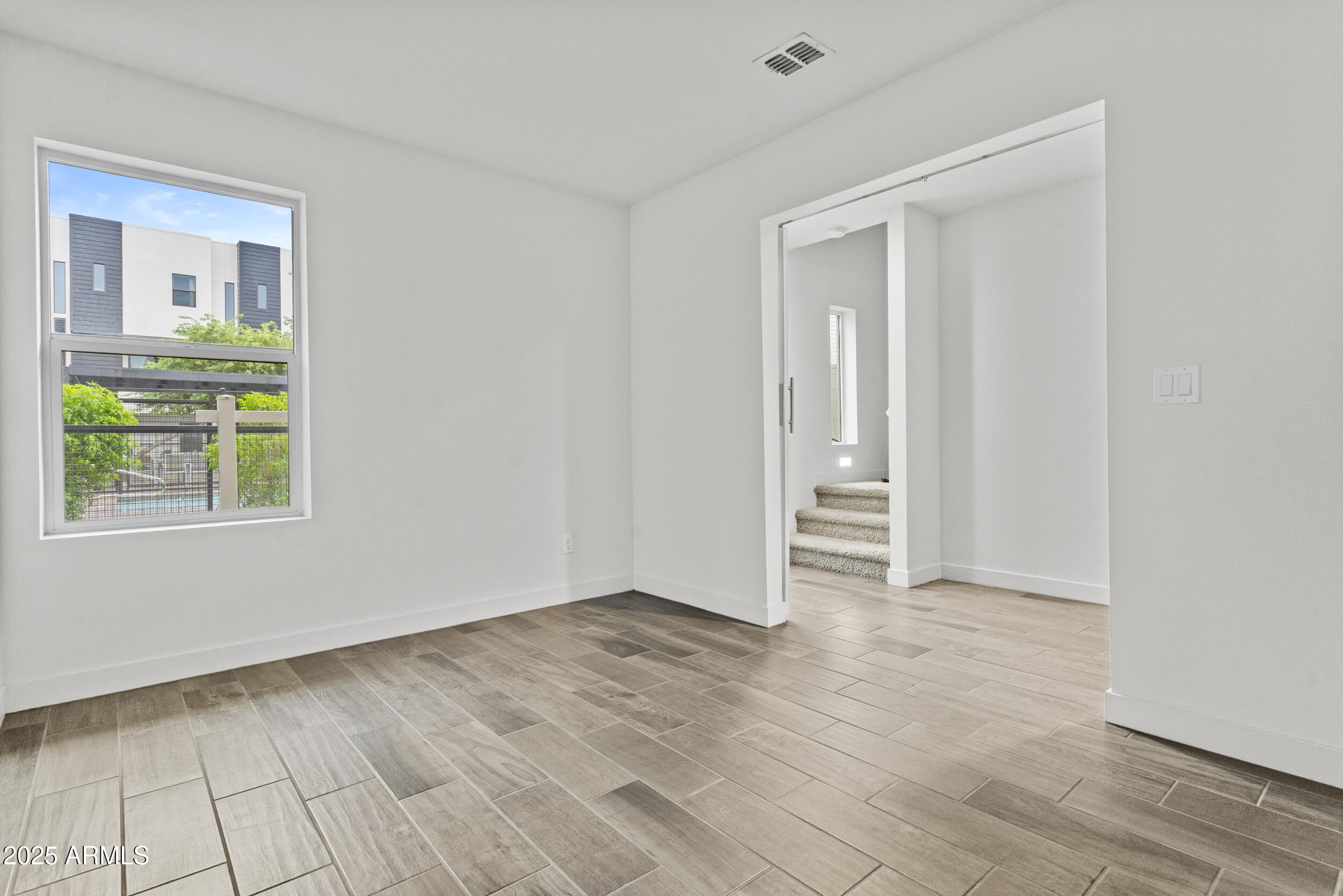 325 East Coronado Road, Unit 8 Phoenix, AZ 85004 - Photo 9 of 34 a view of an empty room with window and wooden floor