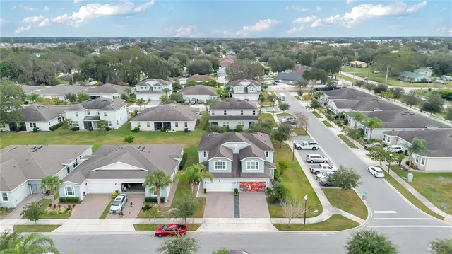an aerial view of residential houses with outdoor space and street view
