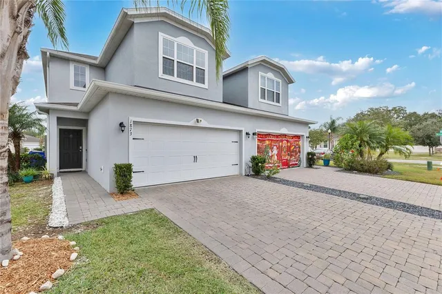 a front view of a house with a yard and garage