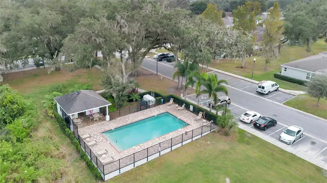 an aerial view of a house with yard swimming pool and outdoor seating