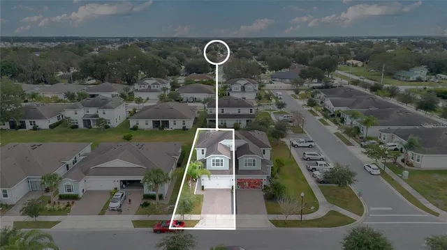 an aerial view of a house with a swimming pool