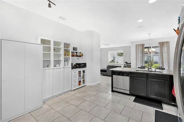 a kitchen with granite countertop cabinets and appliances