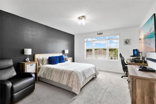 a bedroom with a bed and a couch