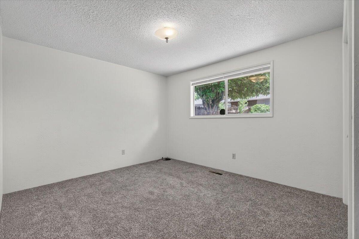 415 Sutter Avenue Medford, OR 97504 - Photo 17 of 28 an empty room with a window
