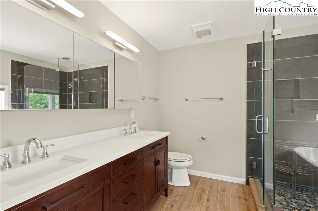 517 Willow Trail Boone, NC 28607 - Photo 11 of 26 a bathroom with a double vanity sink toilet and shower