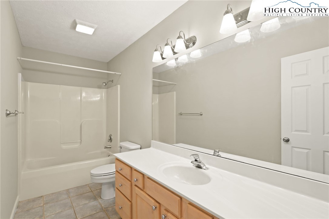 517 Willow Trail Boone, NC 28607 - Photo 13 of 26 a bathroom with a sink a toilet and shower