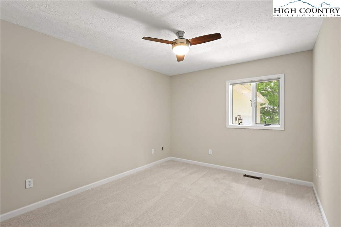 517 Willow Trail Boone, NC 28607 - Photo 14 of 26 an empty room with windows and ceiling fan