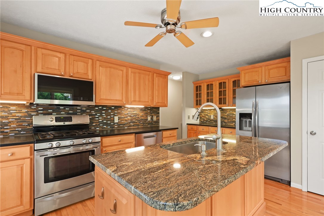 517 Willow Trail Boone, NC 28607 - Photo 2 of 26 a kitchen with stainless steel appliances granite countertop a sink a stove and a microwave