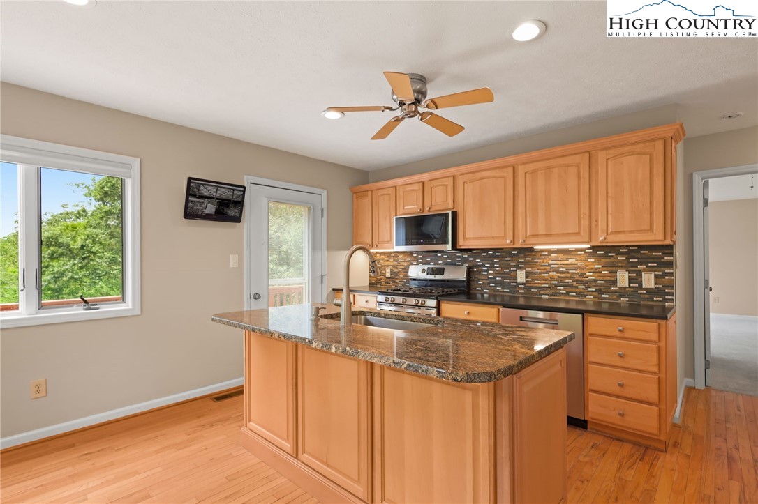 517 Willow Trail Boone, NC 28607 - Photo 3 of 26 a kitchen with stainless steel appliances granite countertop a sink stove and refrigerator