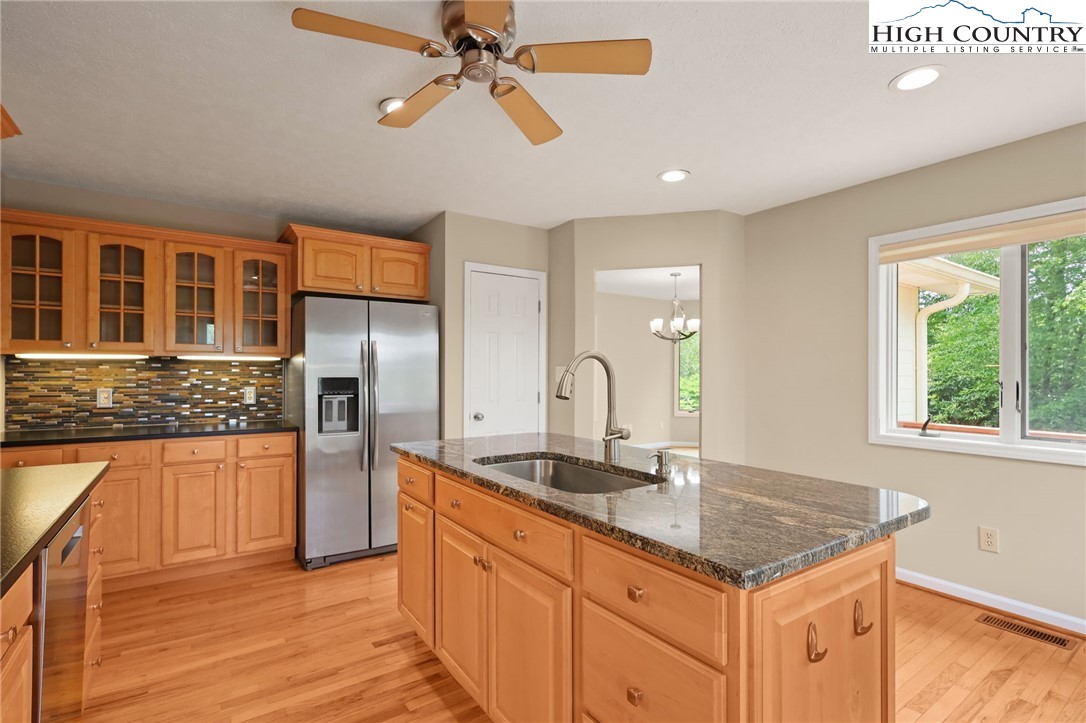 517 Willow Trail Boone, NC 28607 - Photo 4 of 26 a kitchen with stainless steel appliances granite countertop a sink and a refrigerator