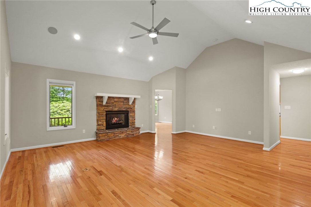 517 Willow Trail Boone, NC 28607 - Photo 6 of 26 an empty room with wooden floor a fireplace and a window