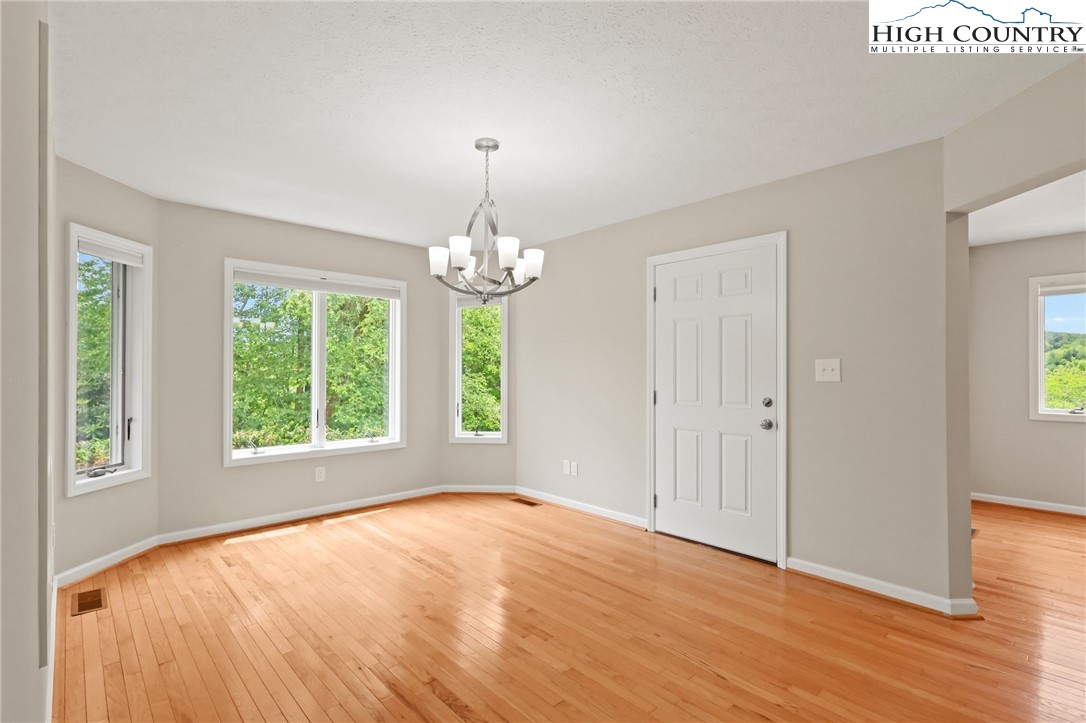 517 Willow Trail Boone, NC 28607 - Photo 8 of 26 a view of an empty room with wooden floor and a window