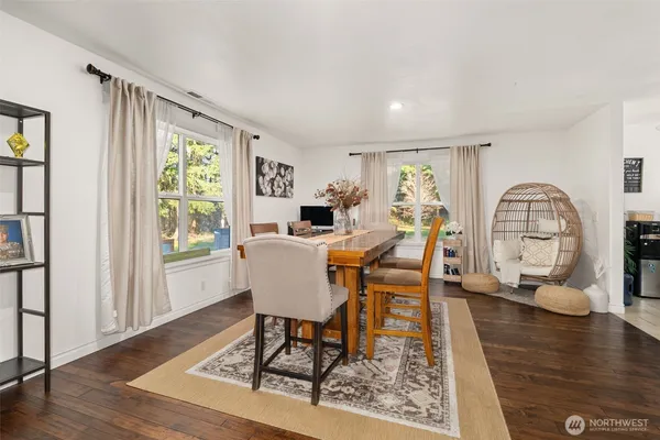 a view of a dining room with furniture window and wooden floor
