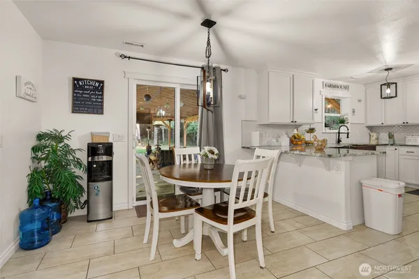 a dining room with furniture and window