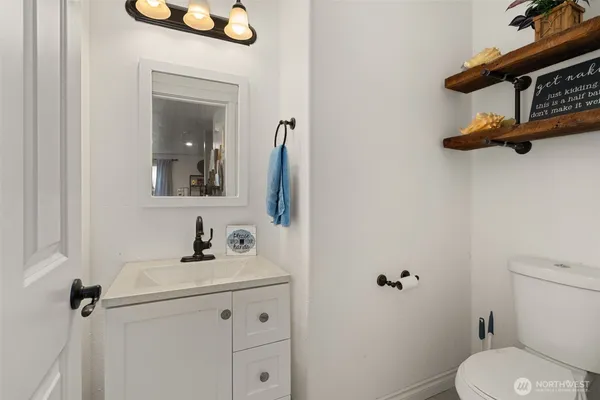 a bathroom with a toilet sink and mirror